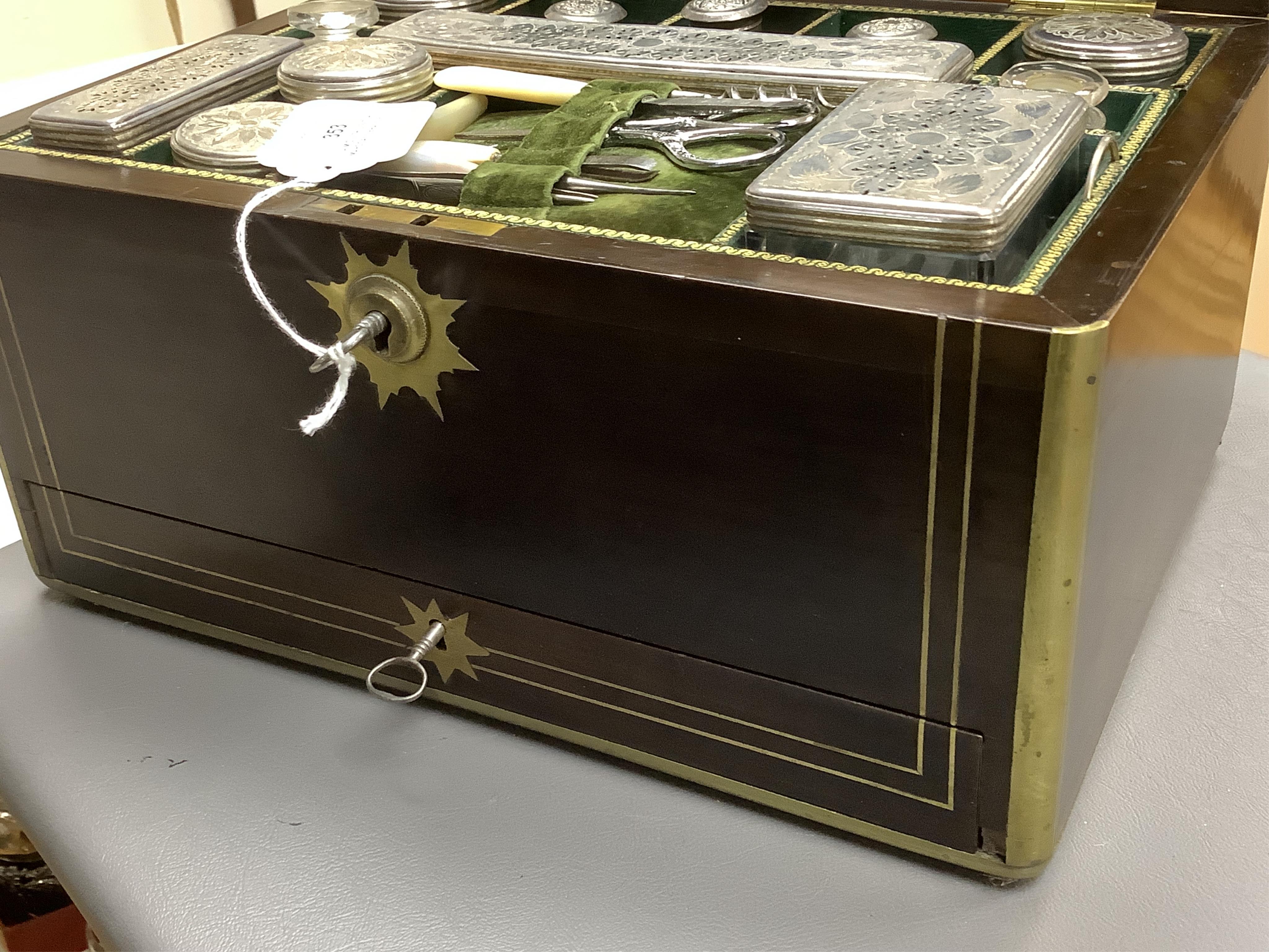 A mid 19th century mahogany brass bound and mounted toilet box, with tooled leather and velvet interior. Fitted inside with glass plated topped bottles and boxes. 31cm wide x 19cm high